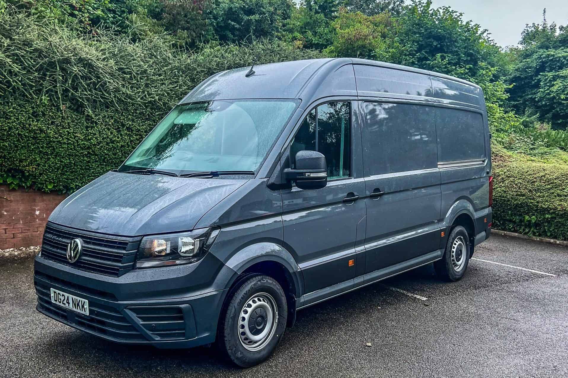 Grey Volkswagen Transporter van parked outdoors, ideal for commercial conversions.