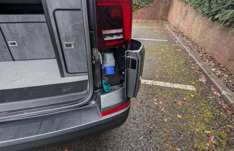 Rear vehicle with water tank and pump system for fluid delivery.