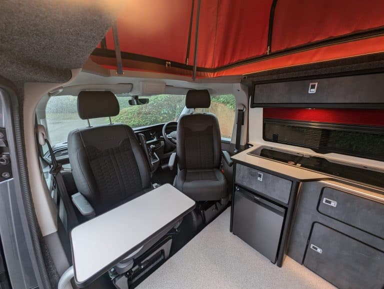 High-quality van conversion interior with seating, storage, and workspace solutions for mobile busin.