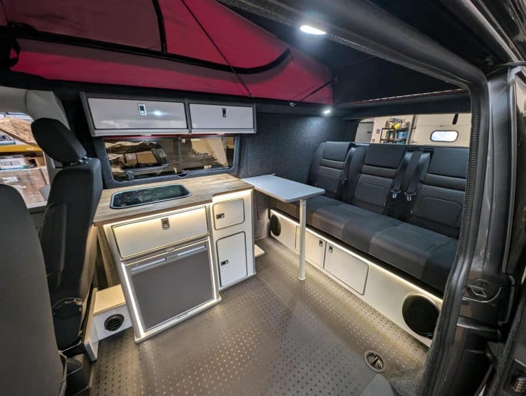 Custom camper van interior with modern amenities for comfortable travel and outdoor adventures.