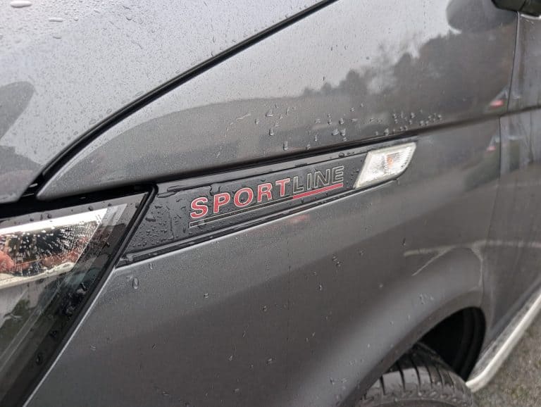 Sportline badge on grey car, highlighting vehicle branding and design details.