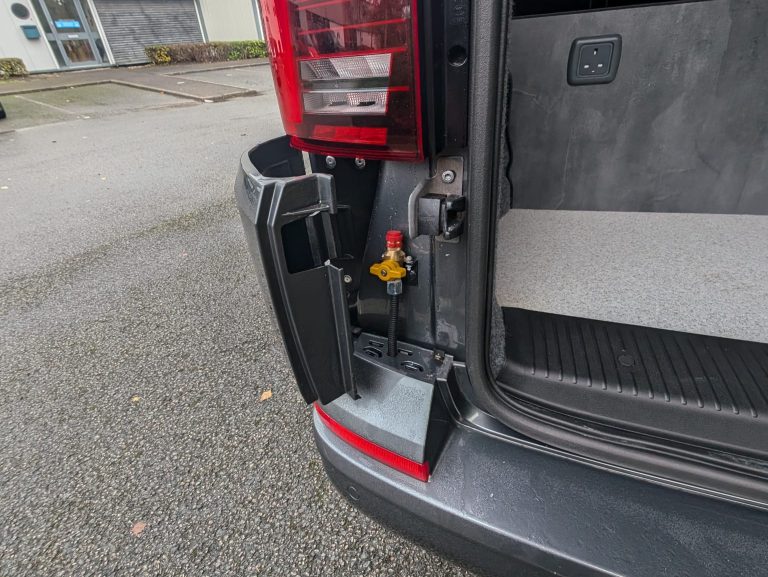 Rear vehicle conversion with water connection and custom fittings.